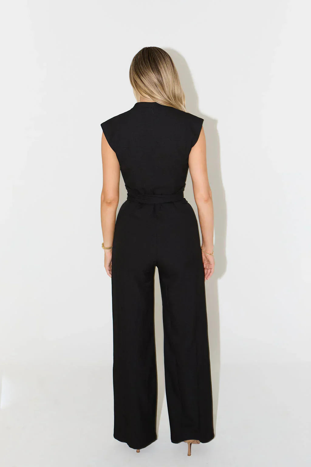 Back view of black wide-leg draped jumpsuit with minimalist cut | Isadora London