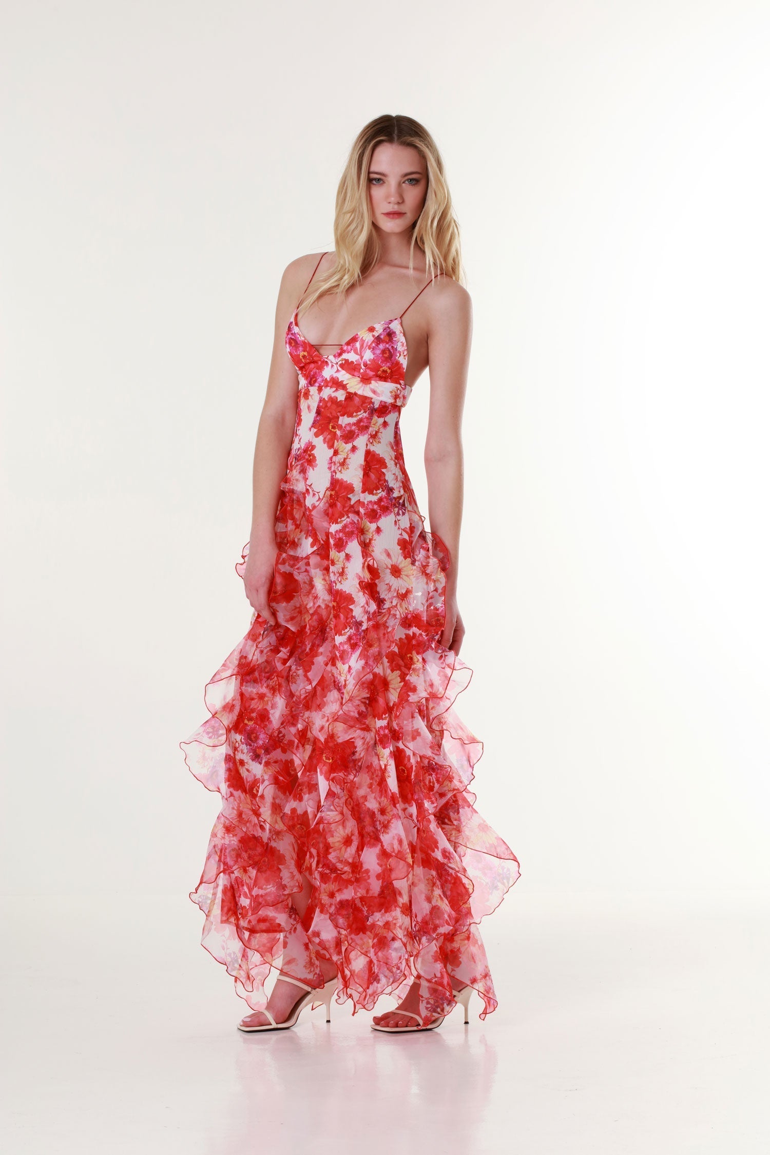 Woman wearing the Isadora London Margot Floral Ruffle Maxi Dress in red, standing confidently in studio