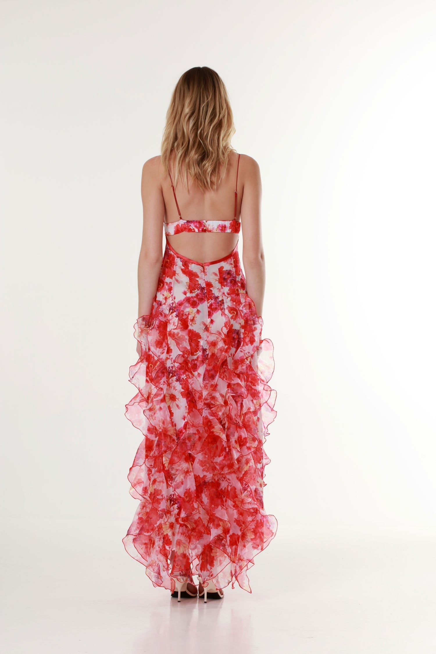 Model in romantic red floral maxi dress with ruffled layers by Isadora London
