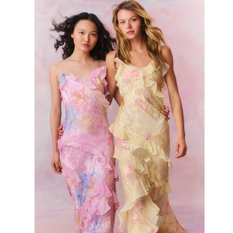 Model wearing Isadora London maxi dress in soft pink and yellow tones
