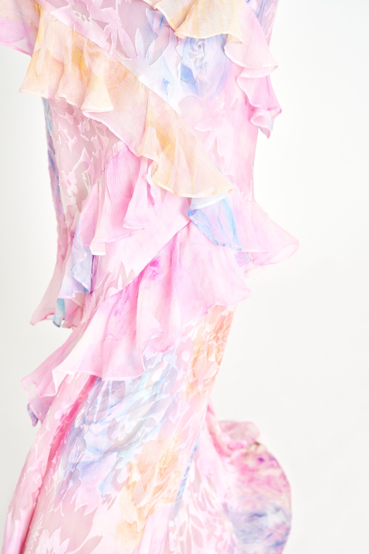 Woman in pastel ruched layered maxi dress by Isadora London, posing in studio