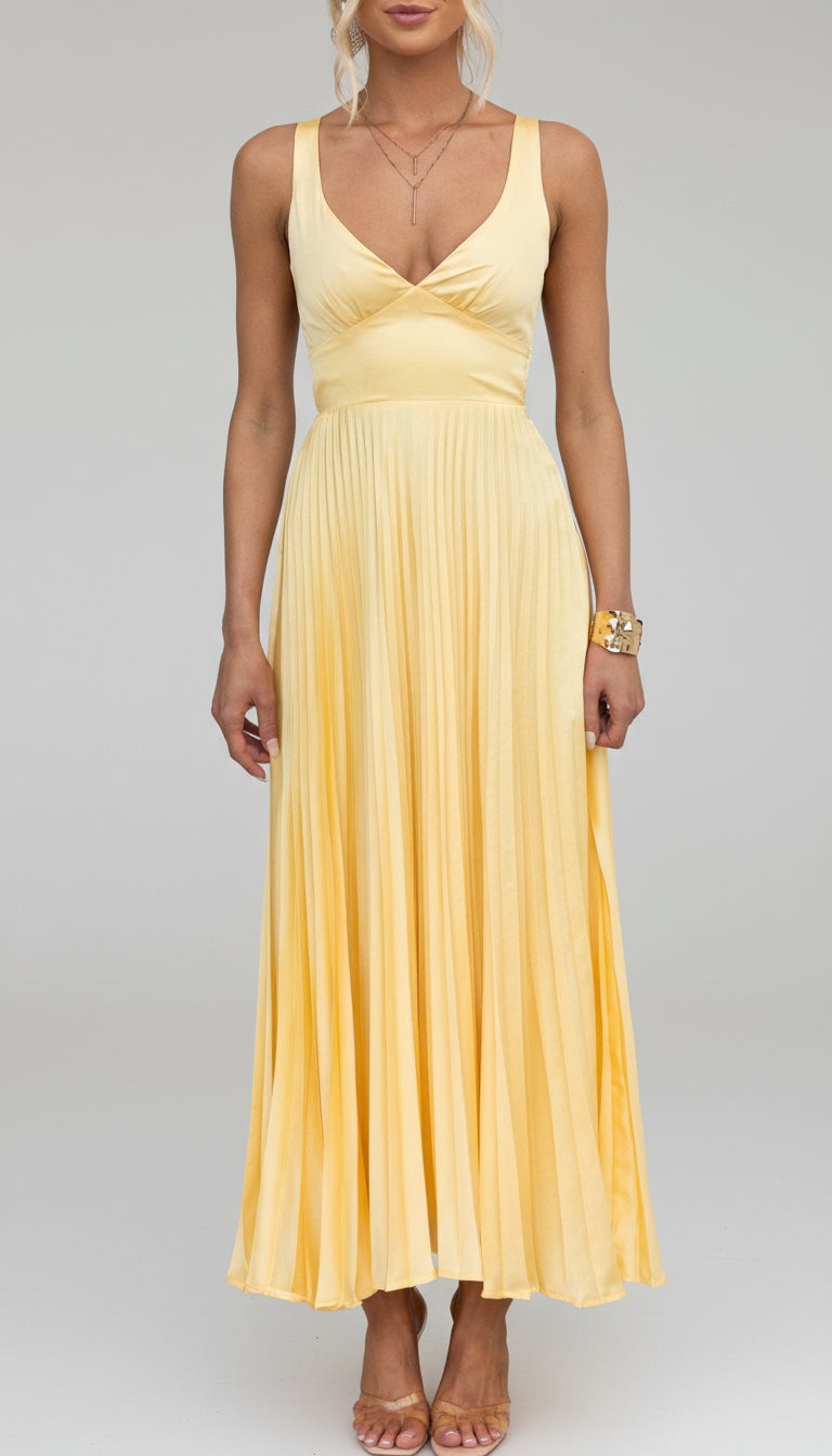 Model wearing the Isadora™ Yellow V-Neck Maxi Dress – elegant pleated summer dress with a flattering wrap neckline and flowy silhouette, perfect for weddings, garden parties, and sunny days.