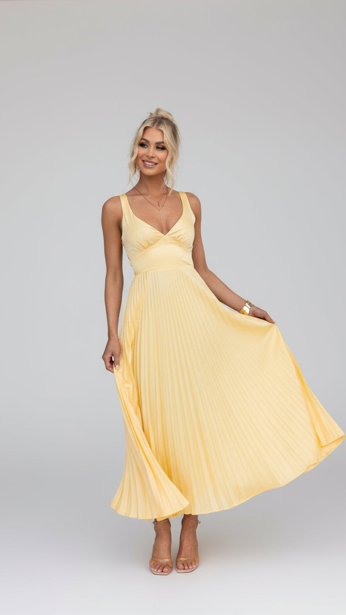 Model wearing the Isadora™ Yellow V-Neck Maxi Dress – elegant pleated summer dress with a flattering wrap neckline and flowy silhouette, perfect for weddings, garden parties, and sunny days.