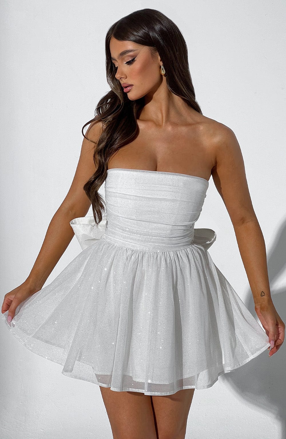 Ivory Sparkle Mini Dress in movement – feminine mini length with shimmering fabric for wedding guests or parties.