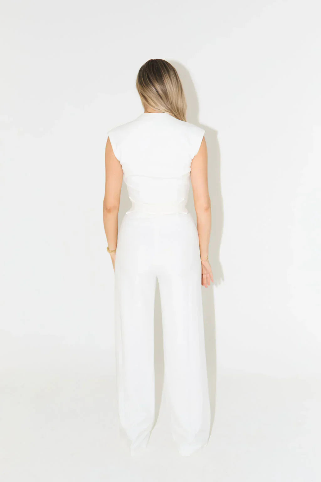 Back view of white timeless draped jumpsuit with structured design | Isadora London