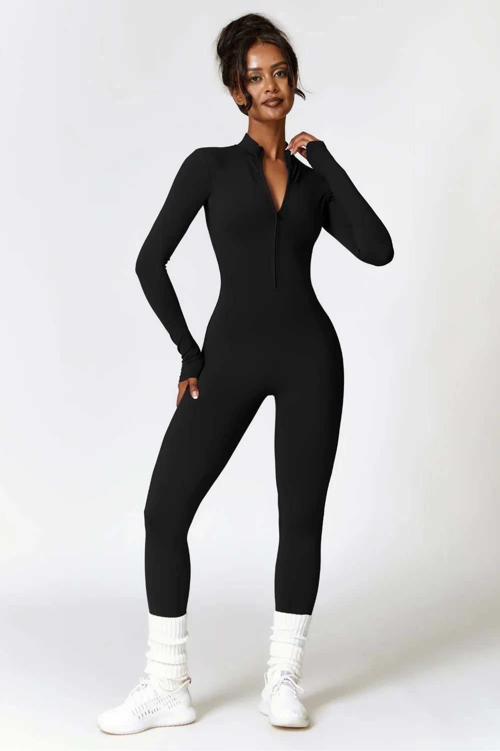 ActiveFlow Jumpsuit in Black – front view, sleek sculpting one-piece with zip neckline