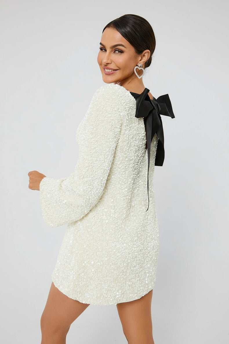 Side view of ivory glitter mini – long sleeves, mini length, all-over sparkle – Isadora London.