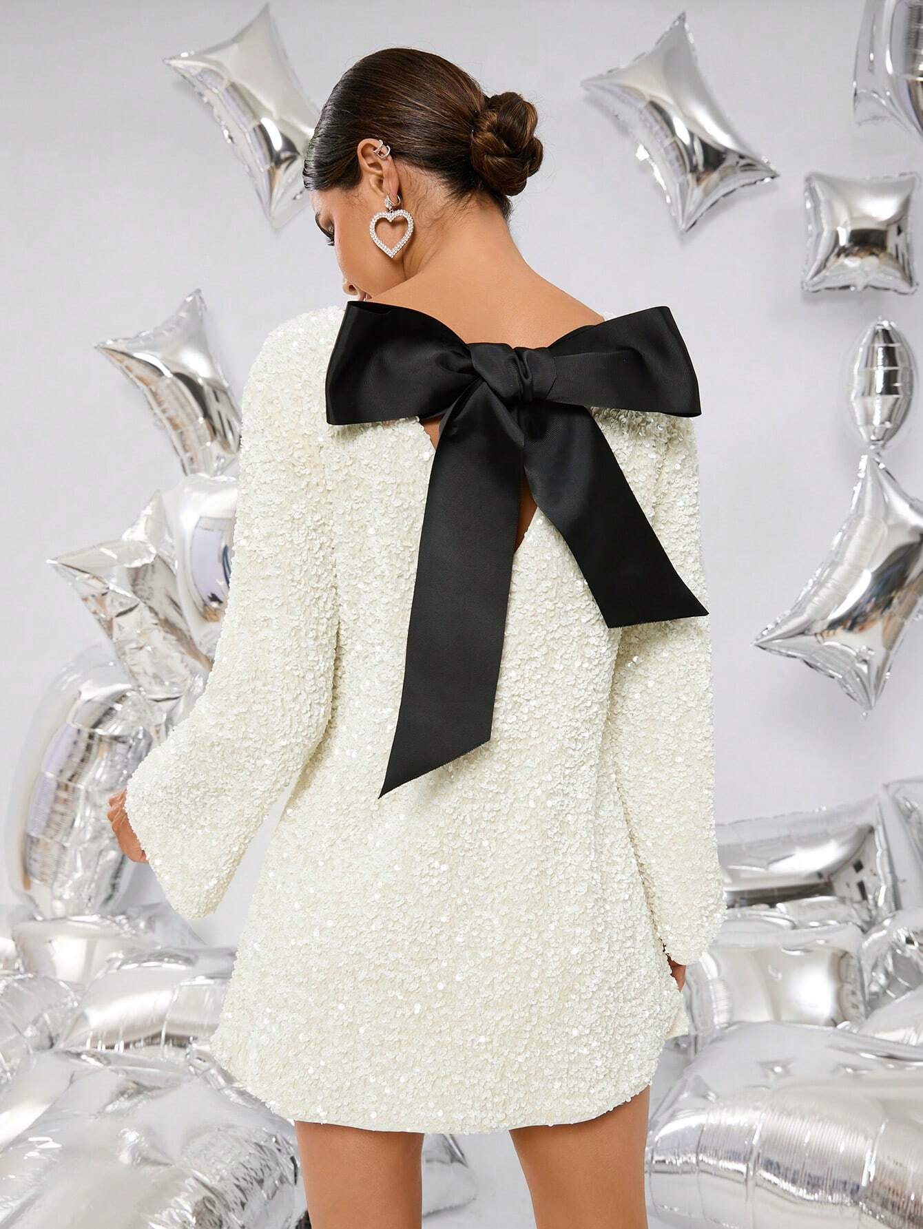 Ivory glitter mini dress back view – statement black bow and low scoop back – Isadora London.