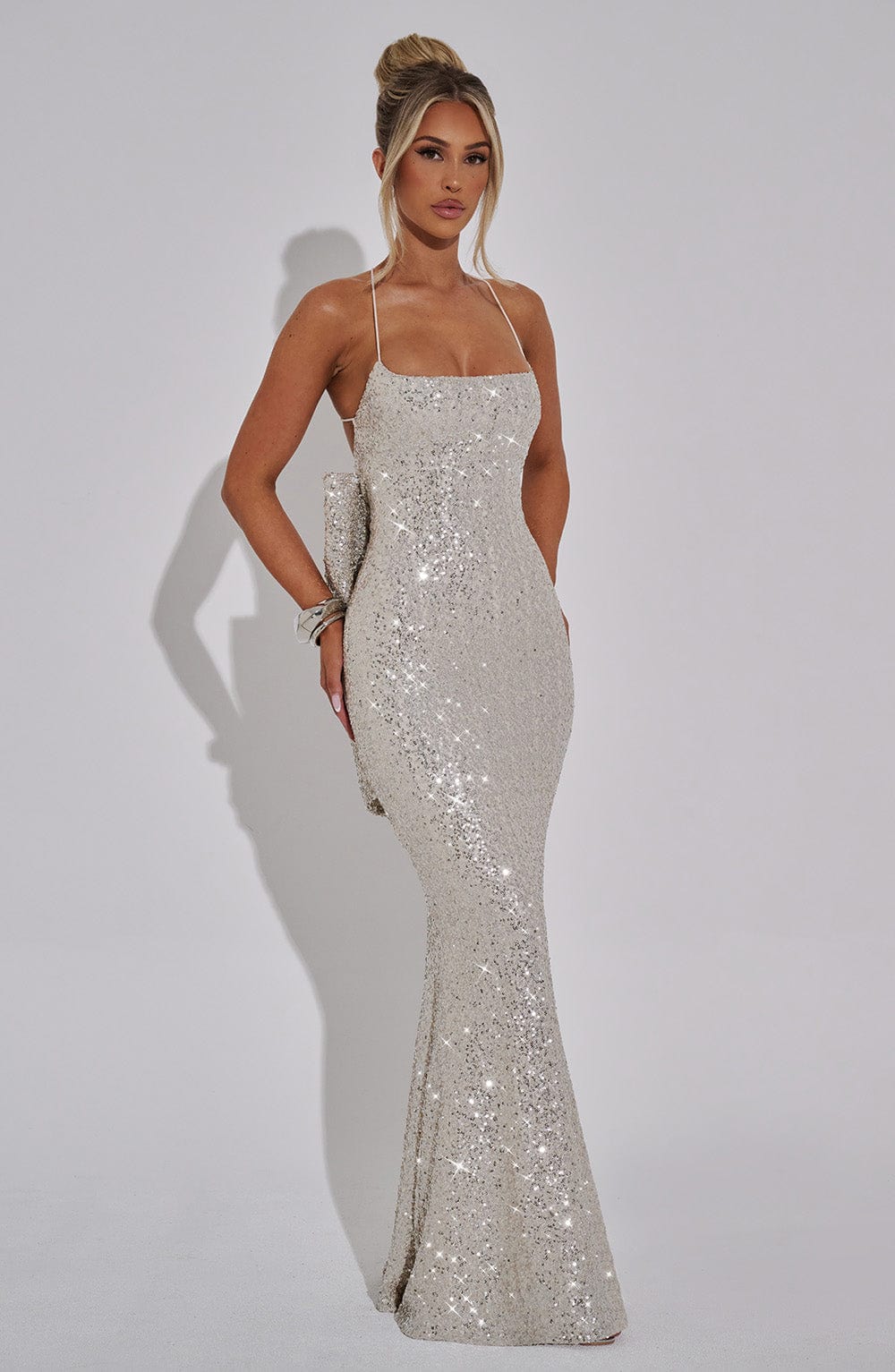 Champagne Glow Maxi Dress with detachable bow detail – chic festive evening gown from Isadora London.
