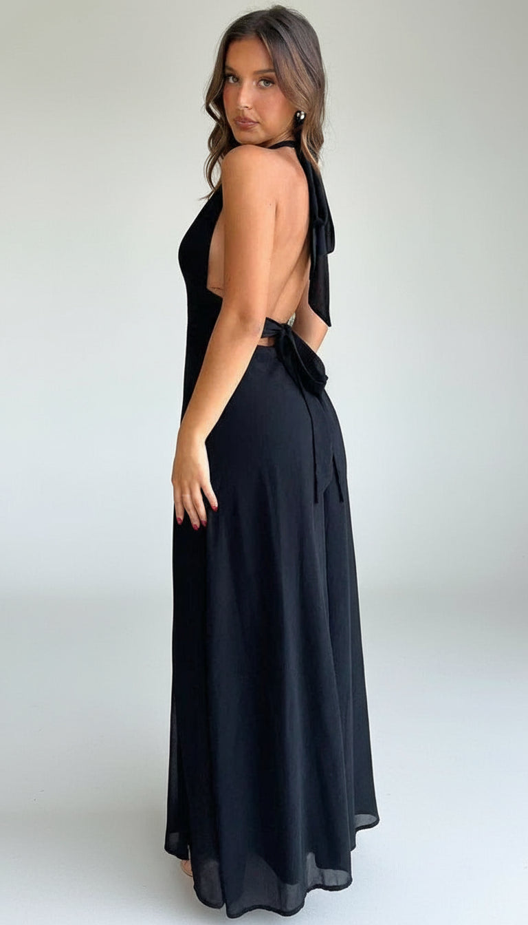 Model wearing the Isadora™ Ethereal Elegance Maxi Dress – stunning black halter-neck gown with a deep V neckline and thigh-high slit.