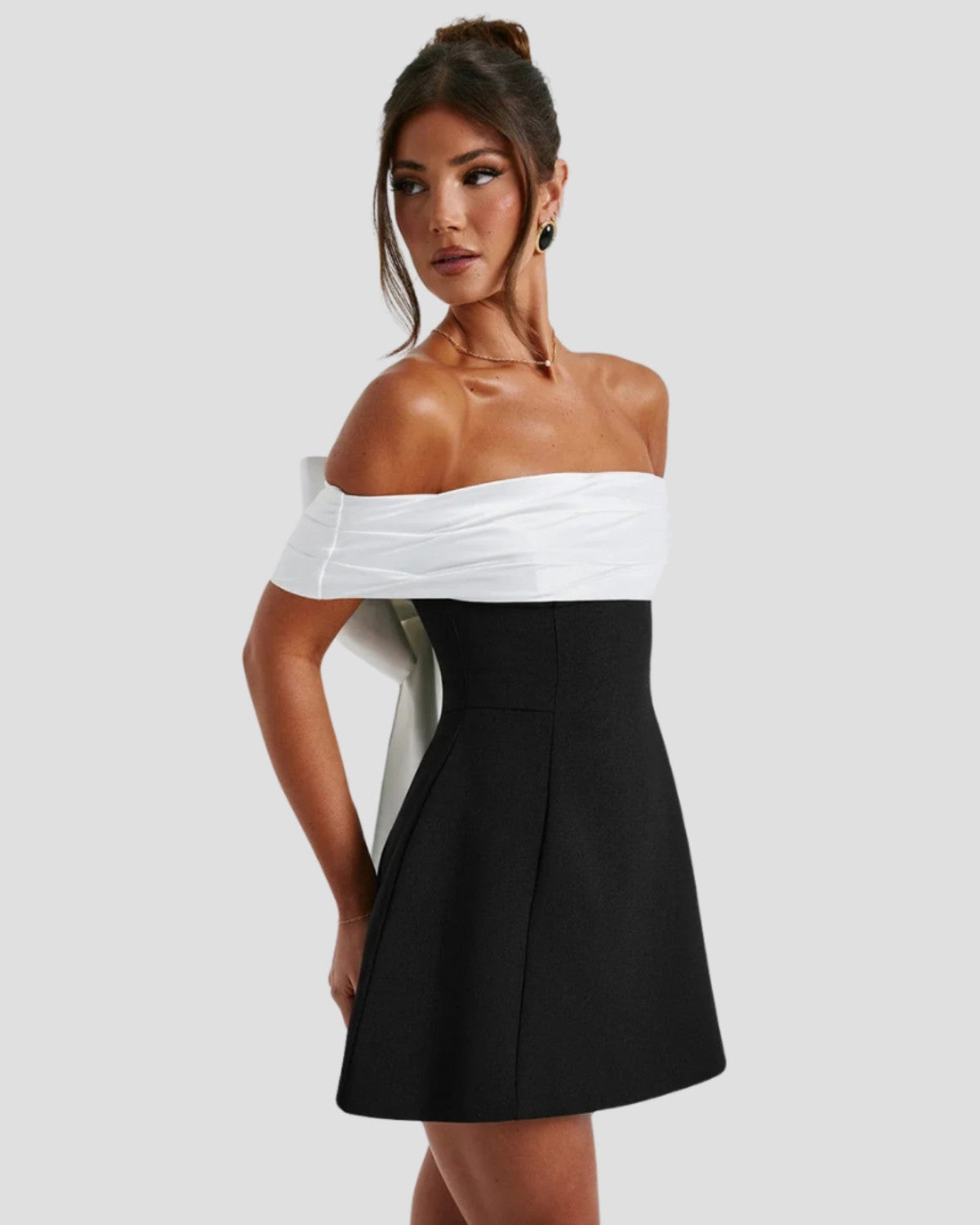 Elegant Bow-Back Mini Dress by Isadora London – side view showing fitted waist and flared mini skirt.