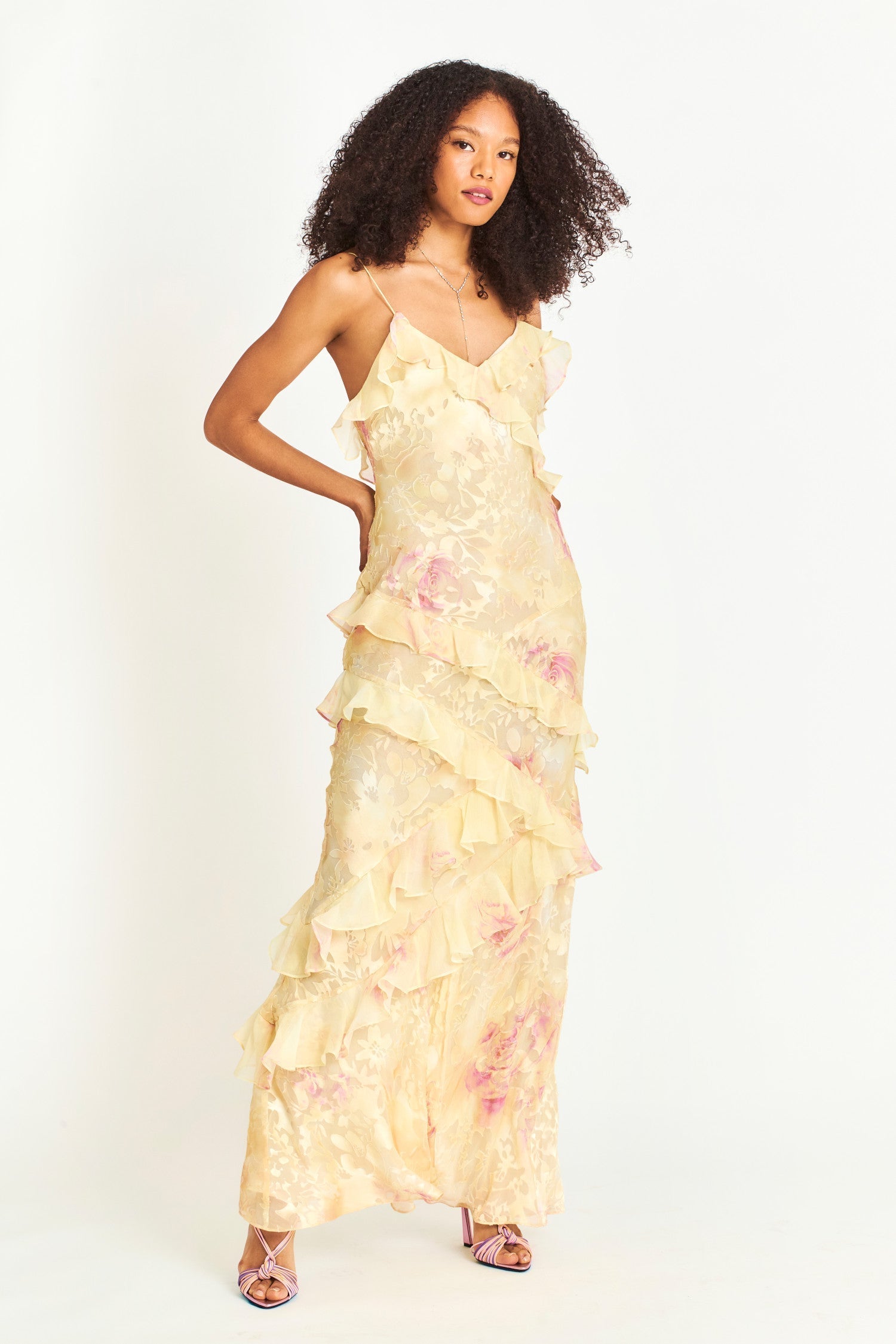 Woman in pastel ruched layered maxi dress by Isadora London, posing in studio
