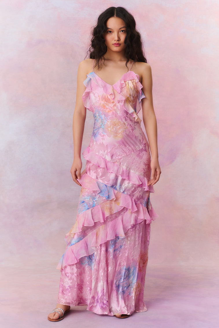 Woman in pastel ruched layered maxi dress by Isadora London, posing in studio