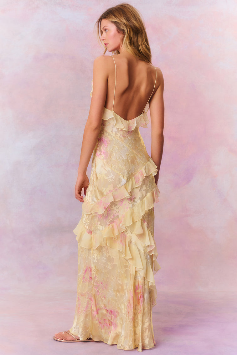 Woman in pastel ruched layered maxi dress by Isadora London, posing in studio