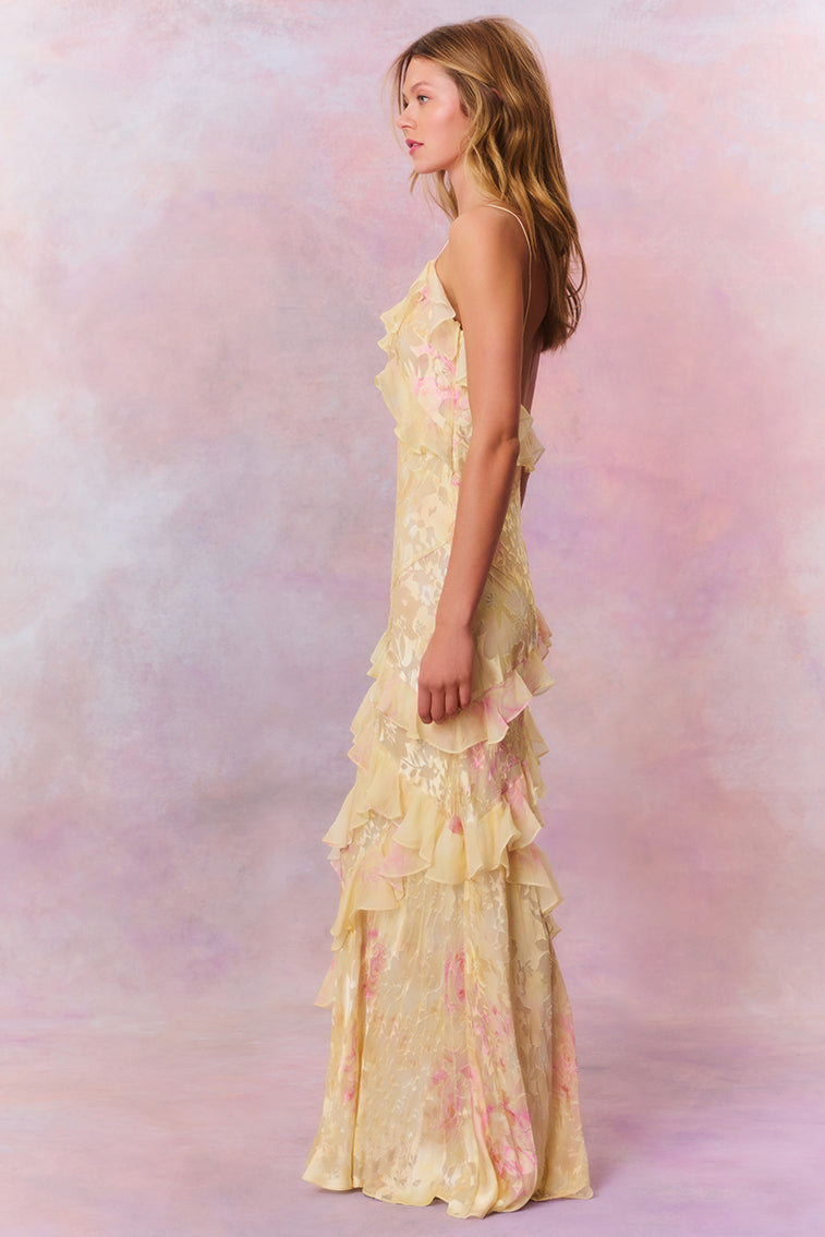 Woman in pastel ruched layered maxi dress by Isadora London, posing in studio
