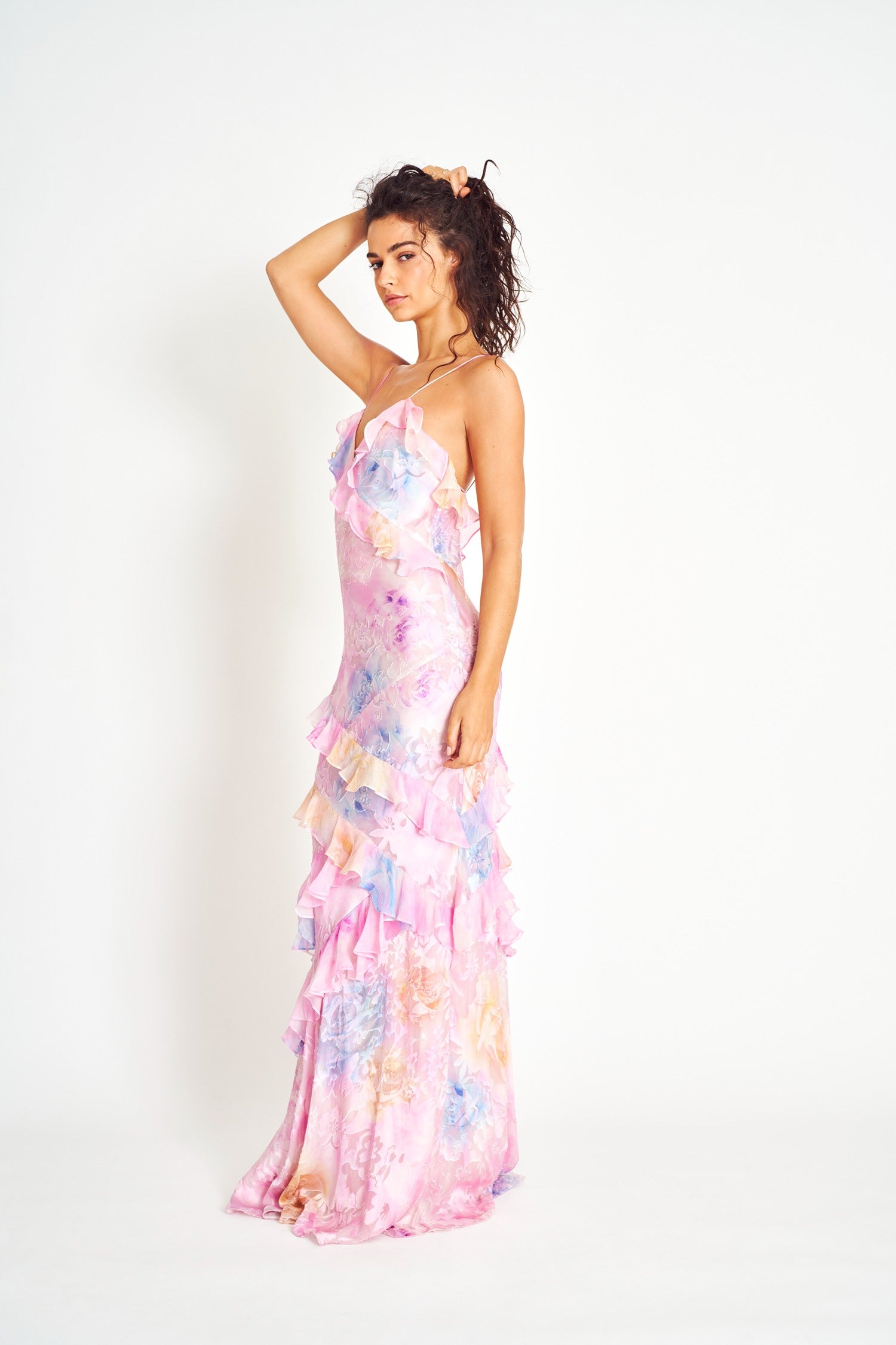 Woman in pastel ruched layered maxi dress by Isadora London, posing in studio