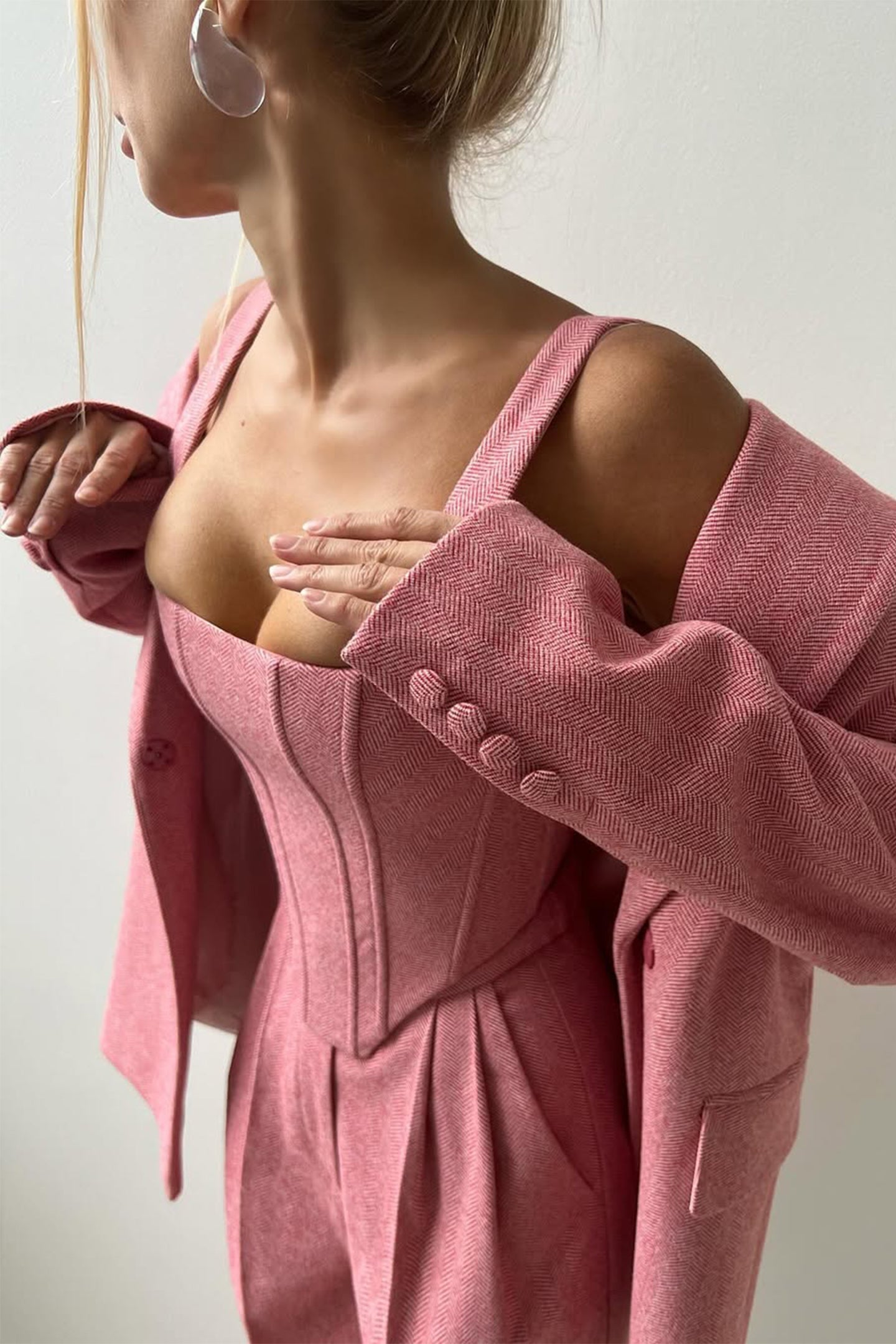 Close-up of pink Isadora London blazer set – feminine tailoring with corset detail.