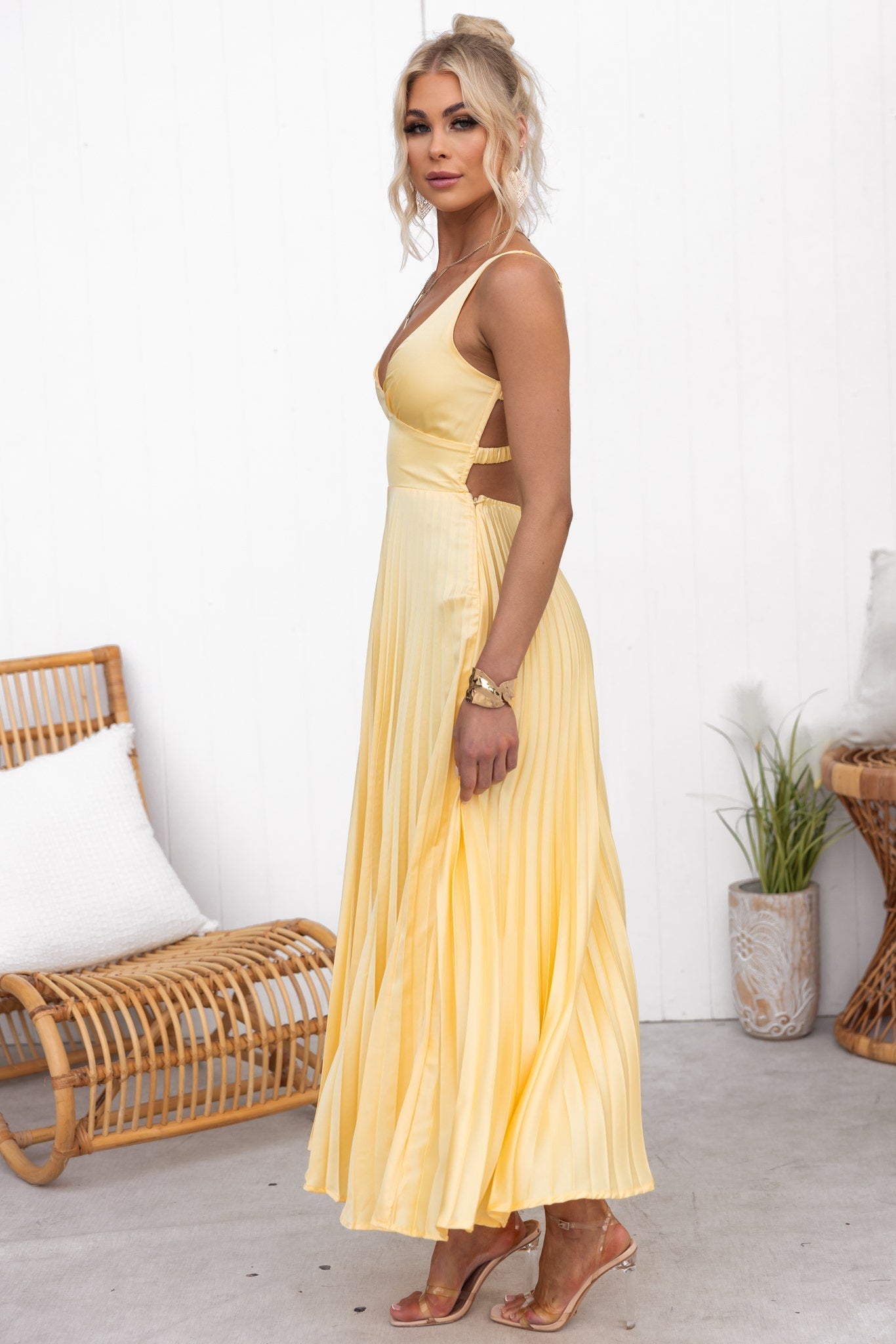 Model wearing the Isadora™ Yellow V-Neck Maxi Dress – elegant pleated summer dress with a flattering wrap neckline and flowy silhouette, perfect for weddings, garden parties, and sunny days.