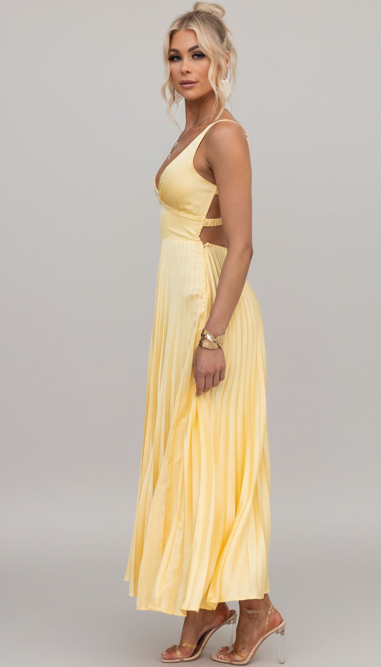 Model wearing the Isadora™ Yellow V-Neck Maxi Dress – elegant pleated summer dress with a flattering wrap neckline and flowy silhouette, perfect for weddings, garden parties, and sunny days.