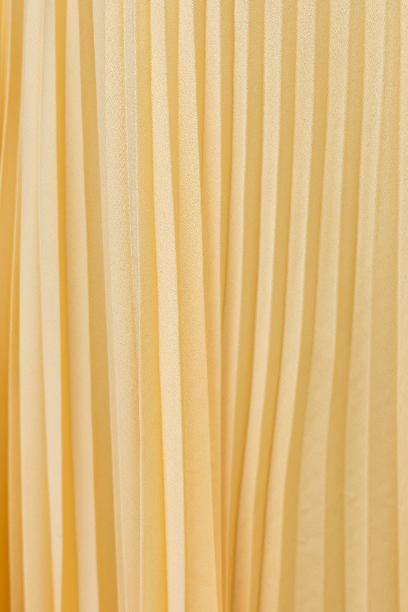 Model wearing the Isadora™ Yellow V-Neck Maxi Dress – elegant pleated summer dress with a flattering wrap neckline and flowy silhouette, perfect for weddings, garden parties, and sunny days.