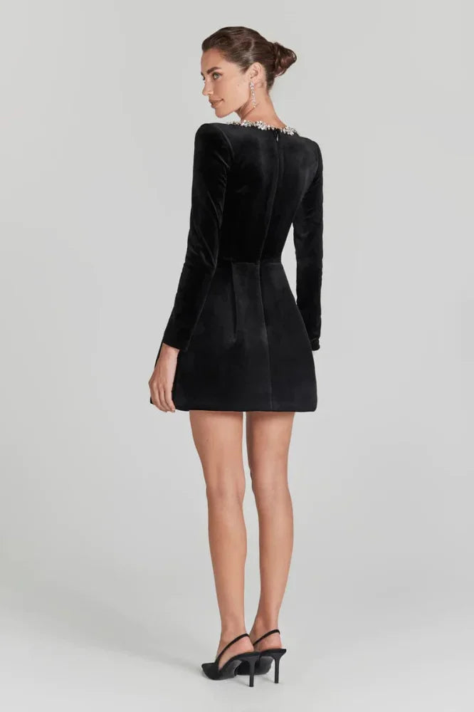 Back view black velvet mini dress – long sleeves, fitted waist; Isadora London.