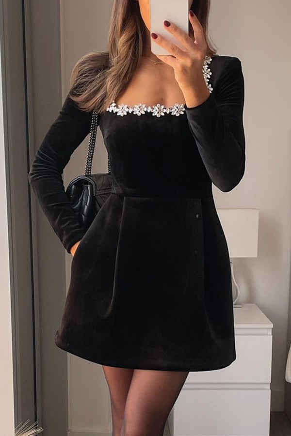 Black velvet long sleeve mini with embellished neckline – party look; Isadora London.