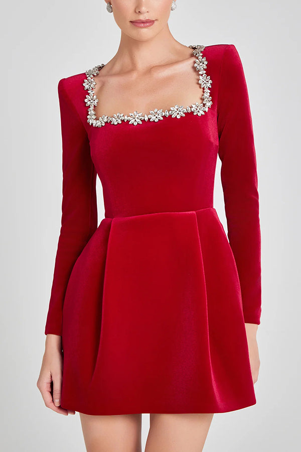 Red velvet long sleeve mini dress – embellished square neckline close-up; Isadora London.