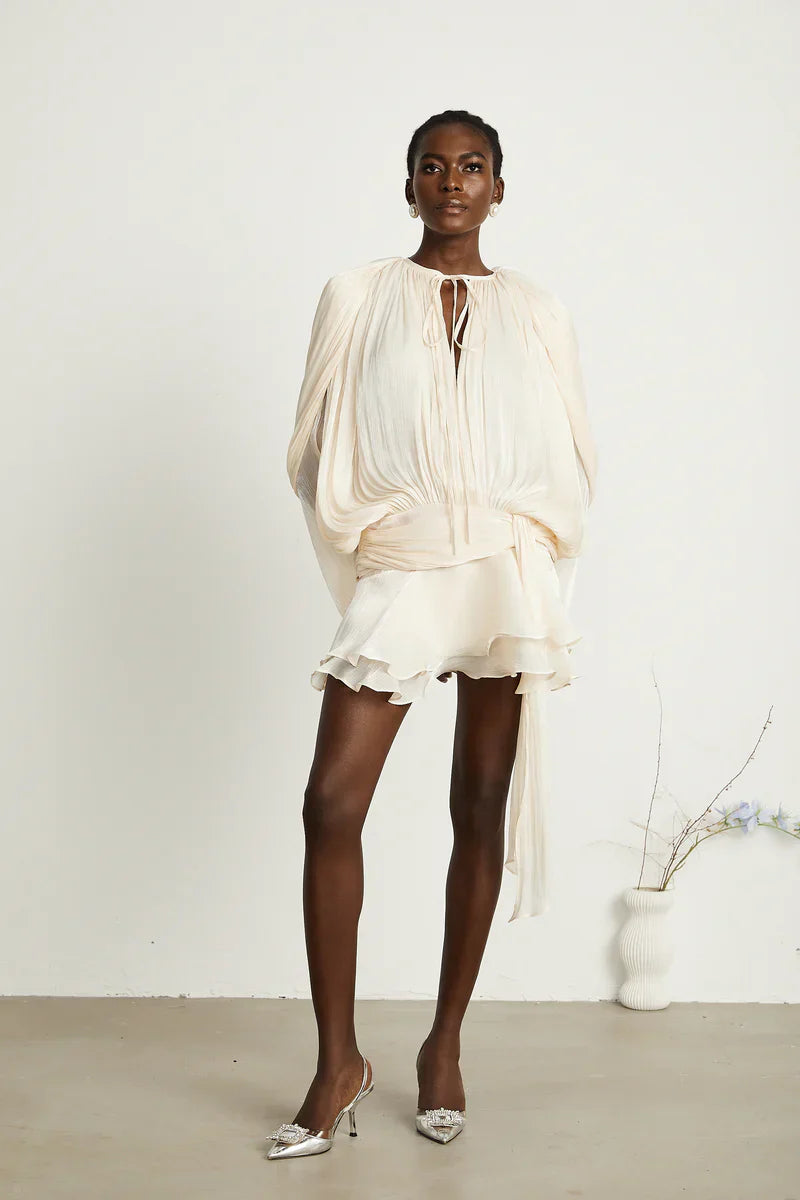 Elegant apricot mini dress by Isadora London – light and flattering fit.