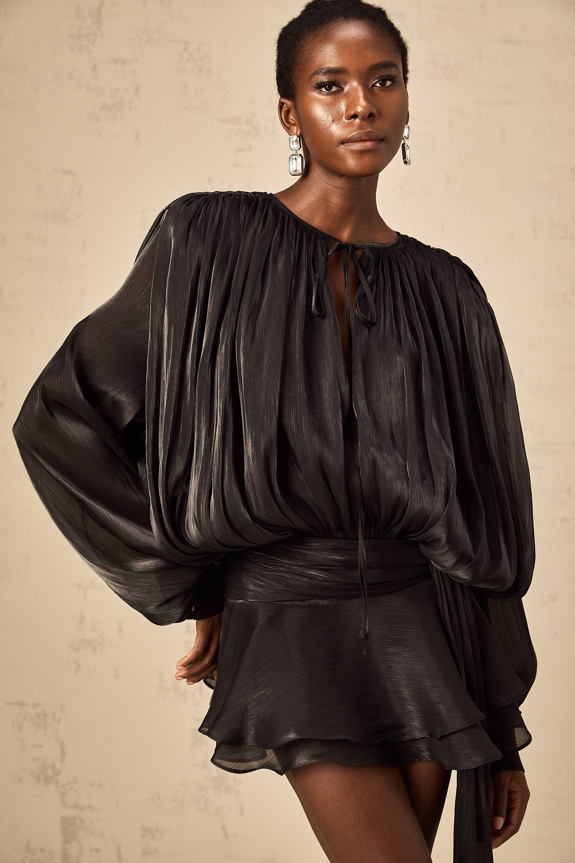 Model in black Luxe Flowy Mini Dress by Isadora London – timeless elegance.