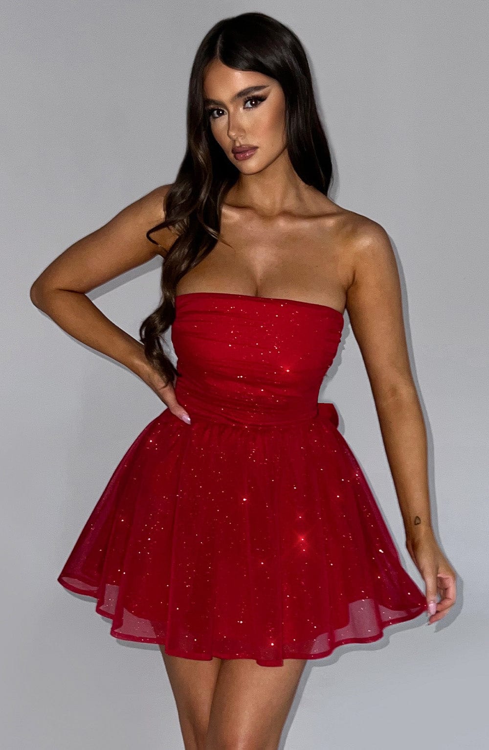Front view of the Red Sparkle Mini Dress – festive red Christmas party dress with corset top and voluminous skirt by Isadora London.