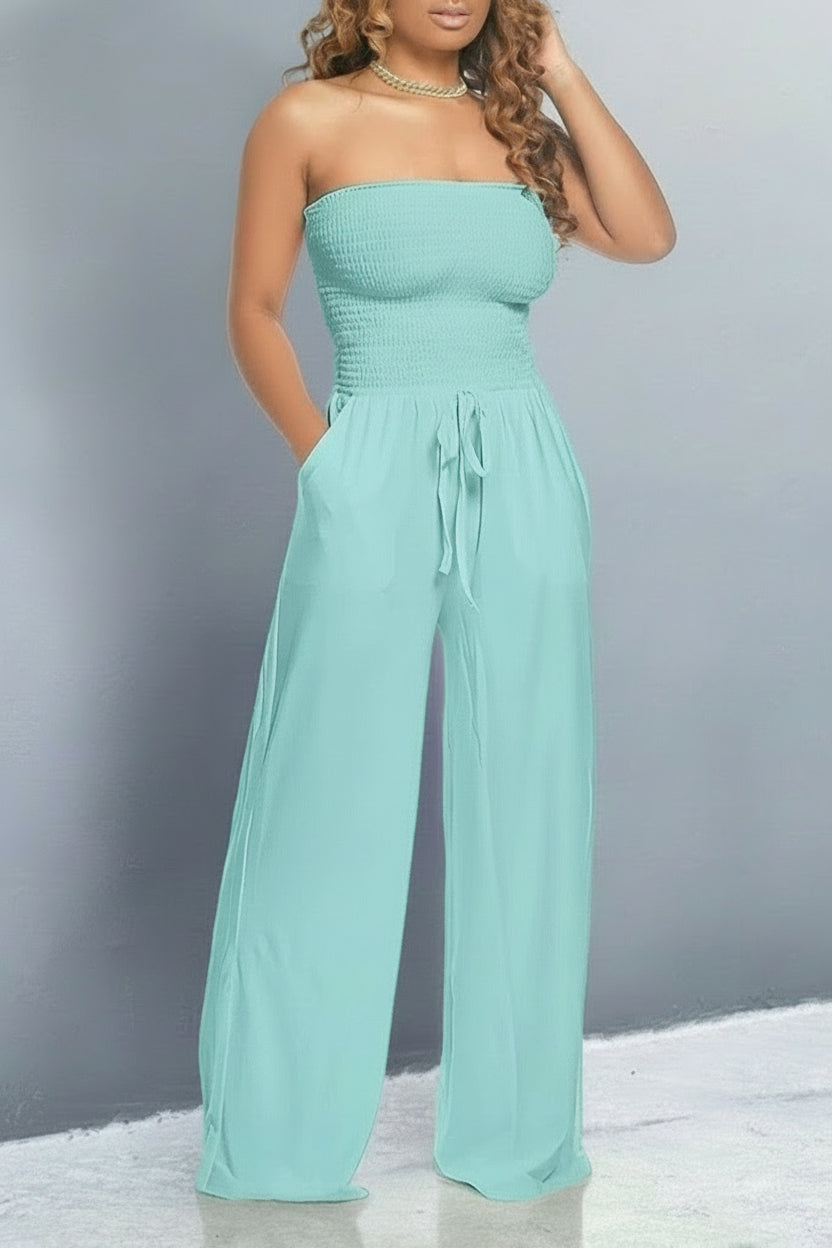 Model wearing a blue off shoulder jumpsuit with smocked bodice, wide-leg fit and tie-waist – casual and flattering style.